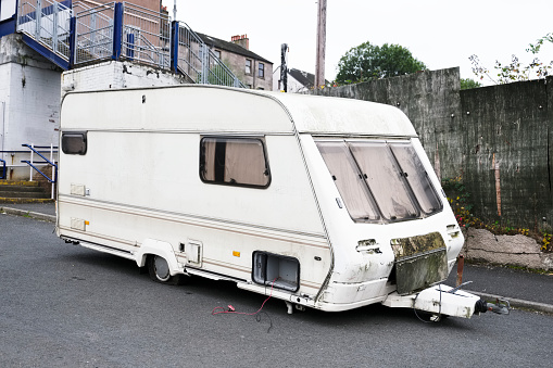 Old caravan dumped broken at roadside by travellers gypsies environmentally unfriendly uk