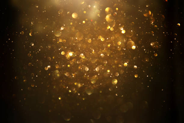 istock glitter vintage lights background. black and gold. de-focused. 1047459960