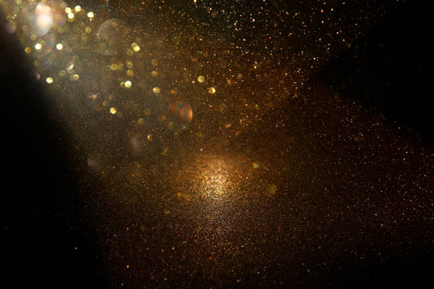 istock glitter vintage lights background. black and gold. de-focused. 1047460080