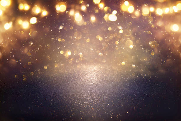 istock glitter vintage lights background. black and gold. de-focused. 1047460260