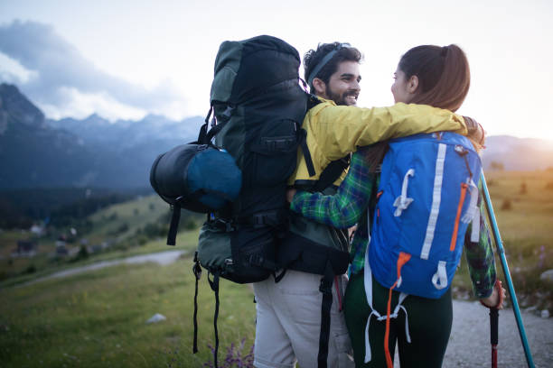 istock Backpackers couple hiking during fall with sticks 1047461080
