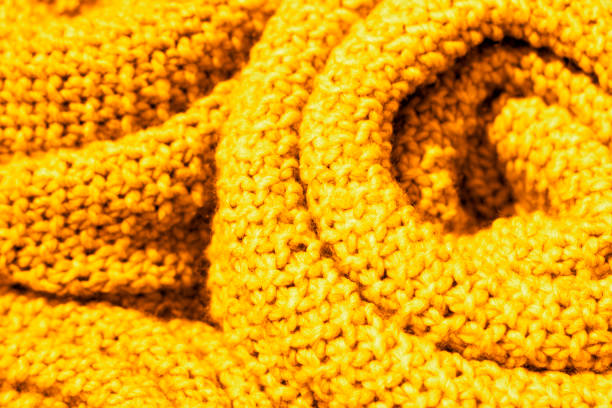 istock Trendy Ceylon yellow color woolen knitted fabric close-up, texture, background 1047475624