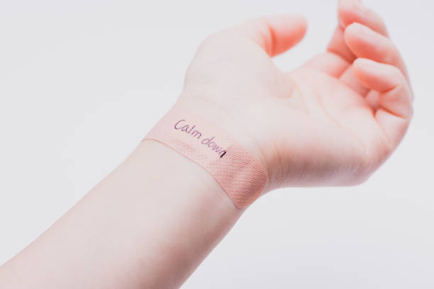 istock Suicide prevention concept: A band aid on wrist with hand writing 