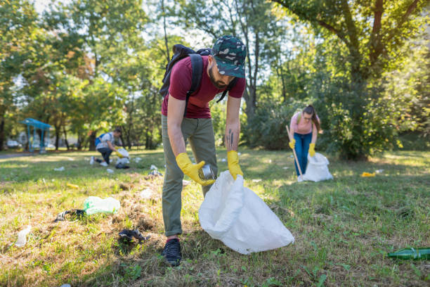 Young man picking litter in the park