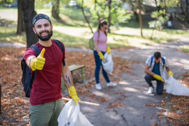 student showing thumbs up for voluntary work done - sustainable resources environment education cleaning imagens e fotografias de stock