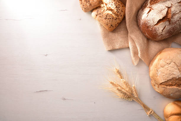 istock Selection of breads on a white table top view 1047484364