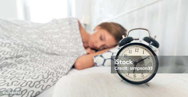 Analog Alarm Clock Woman Sleeping In Bed Stock Photo - Download Image Now - Change, Sleeping, Clock