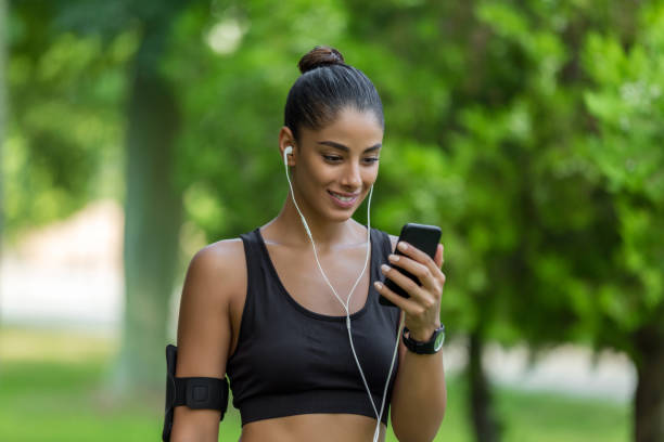 istock Sporty woman using phone 1047489906