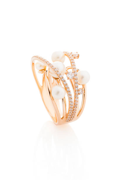 istock Pink gold ring with diamonds and pearls isolated on white 1047494908