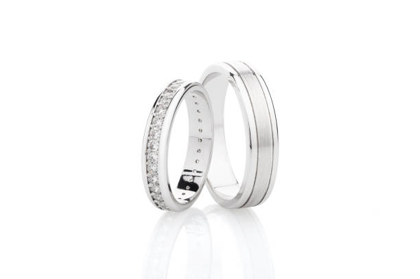 istock Pair of silver wedding rings with diamonds isolated on white background 1047494926