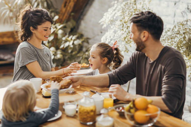 istock Young happy family enjoying in breakfast time at dining table. 1047495594