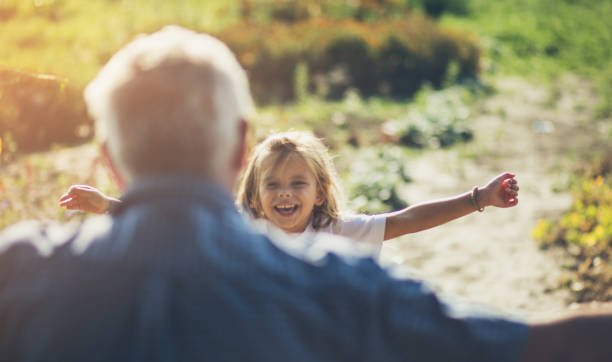 I love you grandpa. Granddaughter running in hug to her grandfather. Copy space. Focus on little girl. Close up. granddaughter stock pictures, royalty-free photos & images