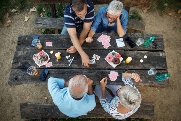 istock Senior people playing cards game 1047498720