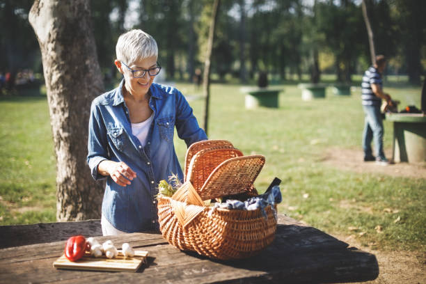istock Senior woman preparing picnic table 1047501906