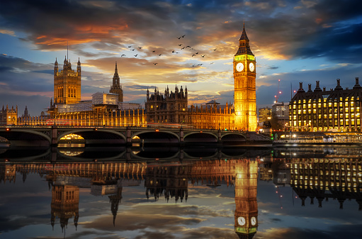 Westminster and the Big Ben clocktower by the Thames river in London, United Kingdom, just after sunset