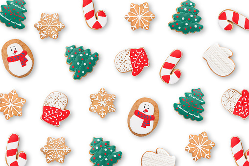 Colorful Christmas gingerbread men. Traditional delicacy of different shapes and colors on a wooden background. With copy space