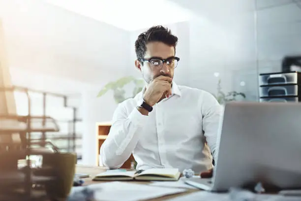 Shot of a young businessman working in an office