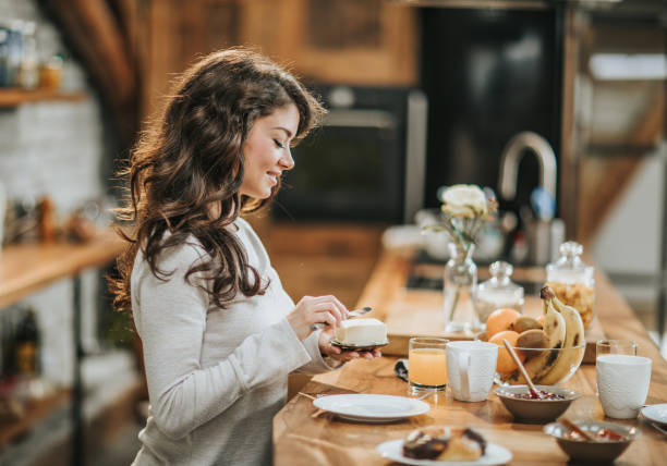 istock Young smiling woman preparing breakfast in the kitchen. 1047508352