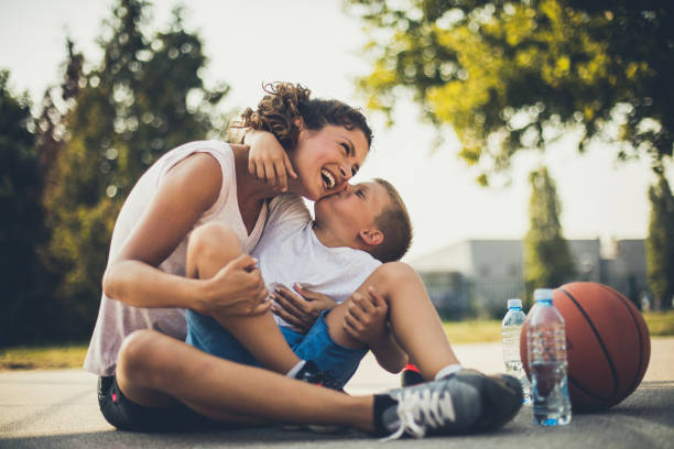 I love you mommy. I love you mommy. Mother and son on playground. basketball sport photos stock pictures, royalty-free photos & images