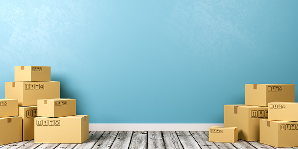 Heaps of Closed Cardboard Boxes on Wooden Floor Against Blue Wall with Copyspace 3D Illustration