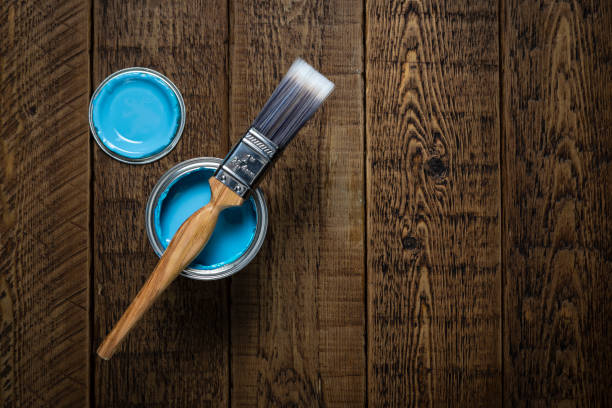 istock Blue paint and brush on wood. 1047512716