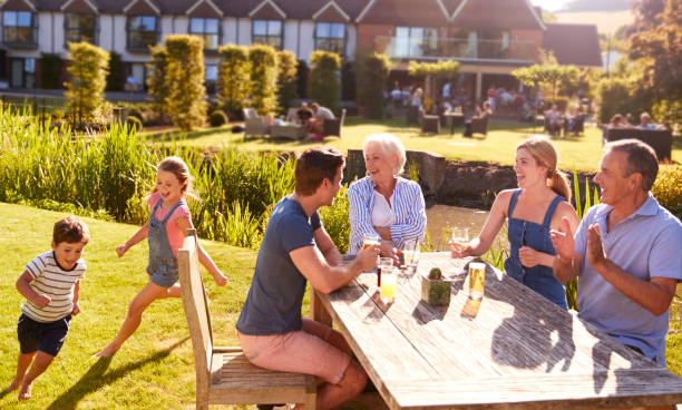 istock Multi Generation Family Enjoying Outdoor Summer Drink At Pub 1047512882