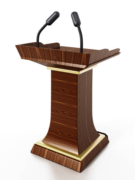 istock Wooden lectern with microphones isolated on white 1047513032