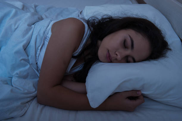 istock The girl is sleeping in bed. night lighting 1047513840