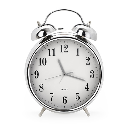 Front view of a shiny vintage analog alarm clock on white background, contains clipping path
