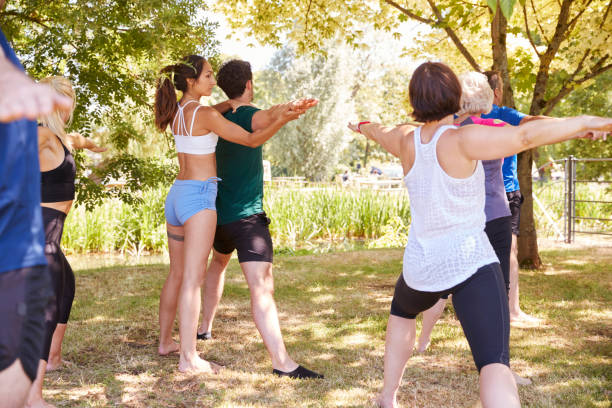 istock Female Instructor Leading Outdoor Yoga Class 1047515030