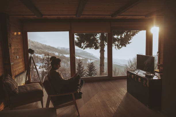 Moment for myself Photo of a young woman enjoying moments alone and reading news online, during her winter vacation in the mountains hygge photos stock pictures, royalty-free photos & images