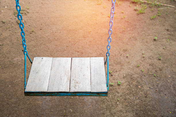 istock High Angle View Of Empty Swing Hanging In Park 1047518018