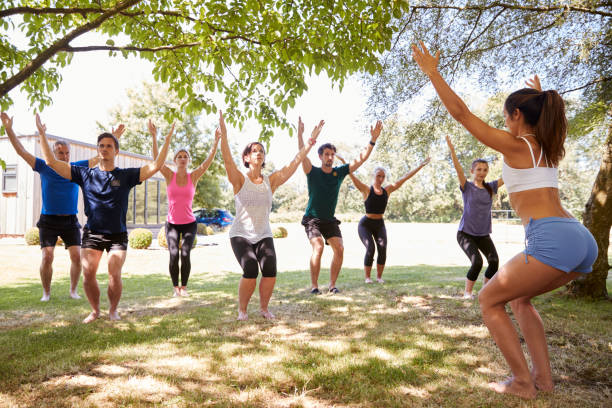 istock Female Instructor Leading Outdoor Yoga Class 1047518032