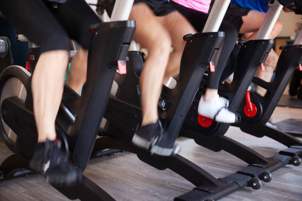 istock Close Up Of Feet On Exercise Bikes In Gym exercising Class 1047519704