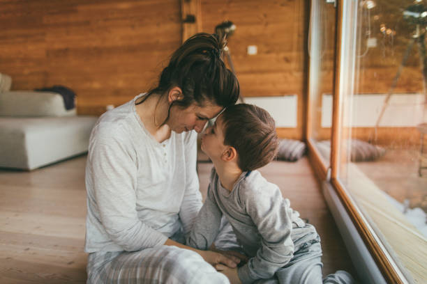 amare mio figlio - mothers day mother kissing child foto e immagini stock