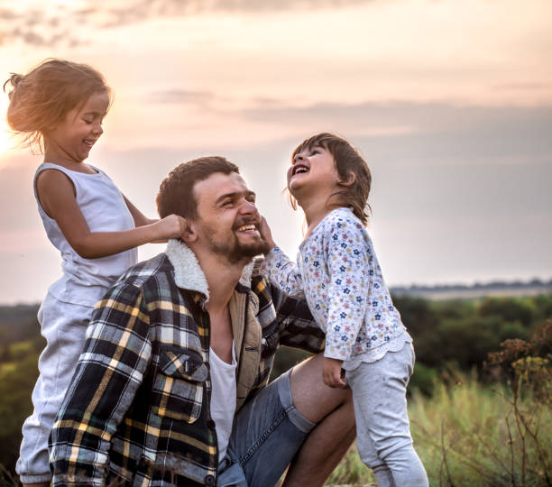 istock dad playing with two little cute daughters 1047520790
