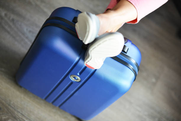 istock Beautiful woman waiting for delayed or connection flight with luggage 1047524170