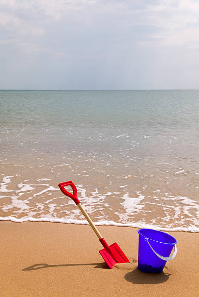 Bucket and spade on a sandy beach.
