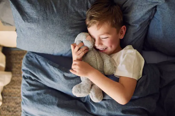 High angle shot of an adorable little boy sleeping in bed at home