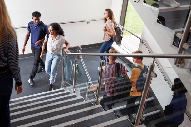 istock High School Students Walking On Stairs Between Lessons In Busy College Building 1047529570