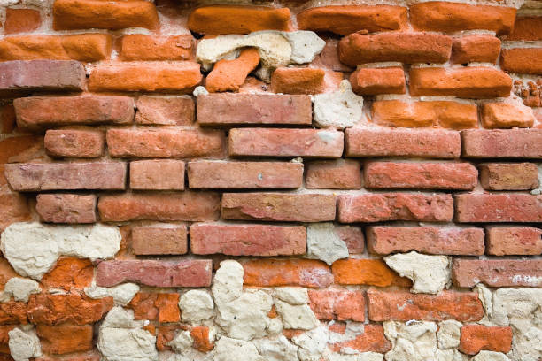 istock Fragment of an old brick wall close-up. 1047529814