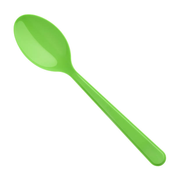 istock Green plastic spoon isolated on white background 1047529912