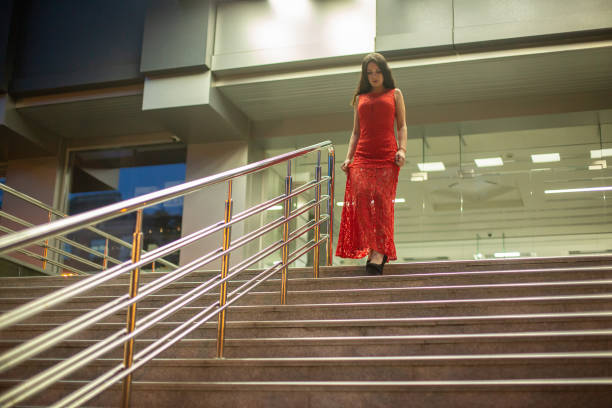istock Gorgeous young girl walking down stairs. 1047532942