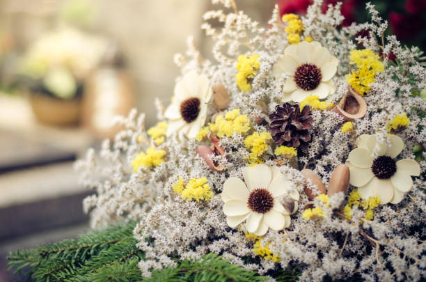 decoration from dry colorful flowers in the cemetery at All Saints Day in autumn time