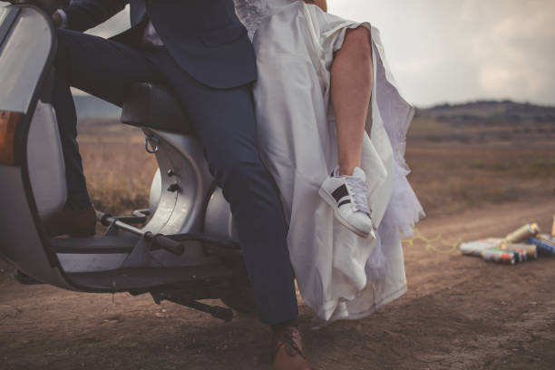 Just married couple on the vespa motorbike going on the honeymoon