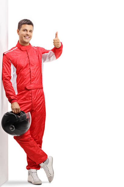 istock Racer leaning against a wall and holding his thumb up 1047544892
