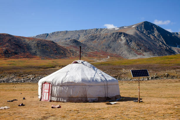 Sun powered traditional Mongolian ger in Altai Mountains Mongolia Traditional Mongolian portable round tent ger covered with white outer cover powered by solar panel in Altai Mountains of Western Mongolia yurt photos stock pictures, royalty-free photos & images