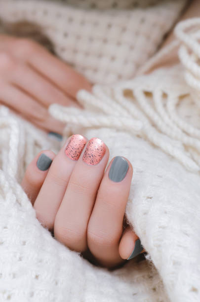 Female hand with pink and gray nail design Female hand with pink and gray nail design. fall nail art stock pictures, royalty-free photos & images