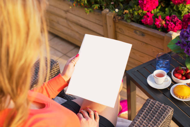 istock Woman reading blank sample page, empty template for your own design. 1047553360
