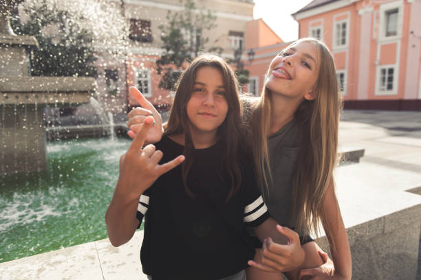 Two teenage girls having fun in the urban part of the city.